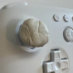 Image of a controller with putty applied on its analog stick.